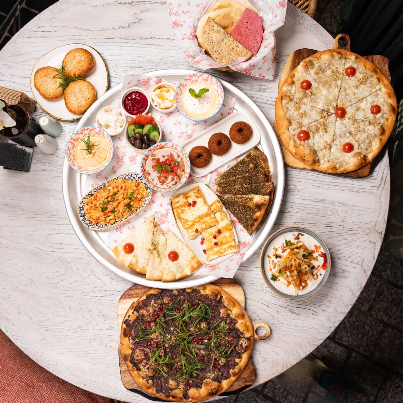 A weekend brunch spread of feta, walnuts, fresh herbs, honey, and warm barbari bread